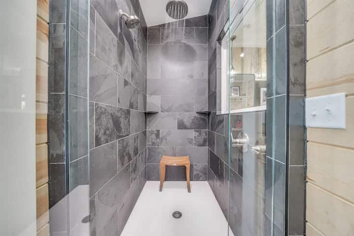Large shower w/ rain overhead and standard wall faucet
